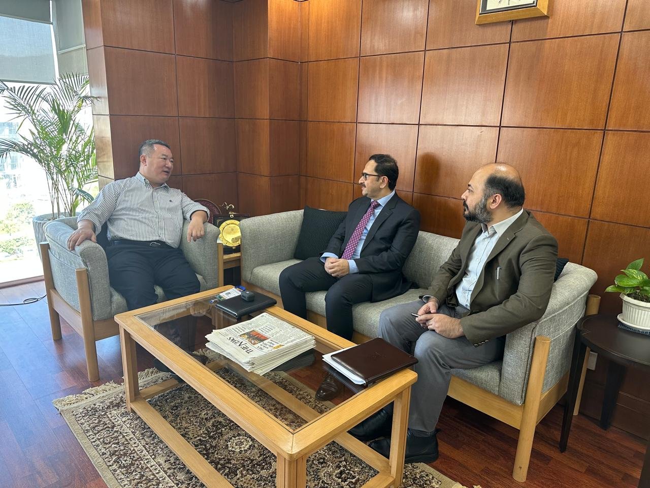 Bilal Anwar and a colleague receiving a visiting counterpart for a courtesy call