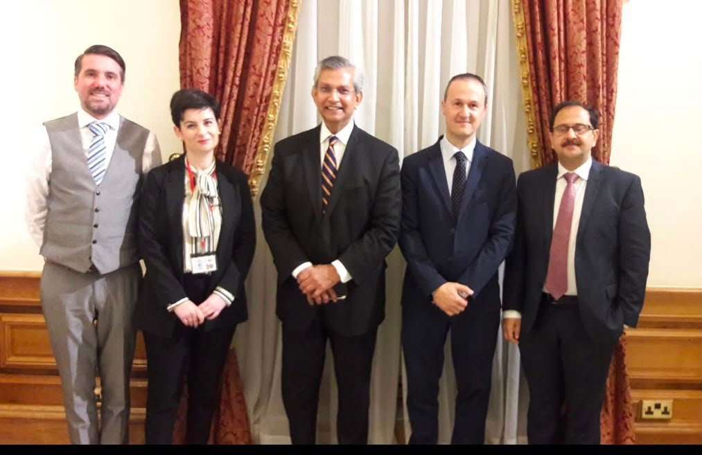 Bilal Anwar with colleagues in a formal meeting room