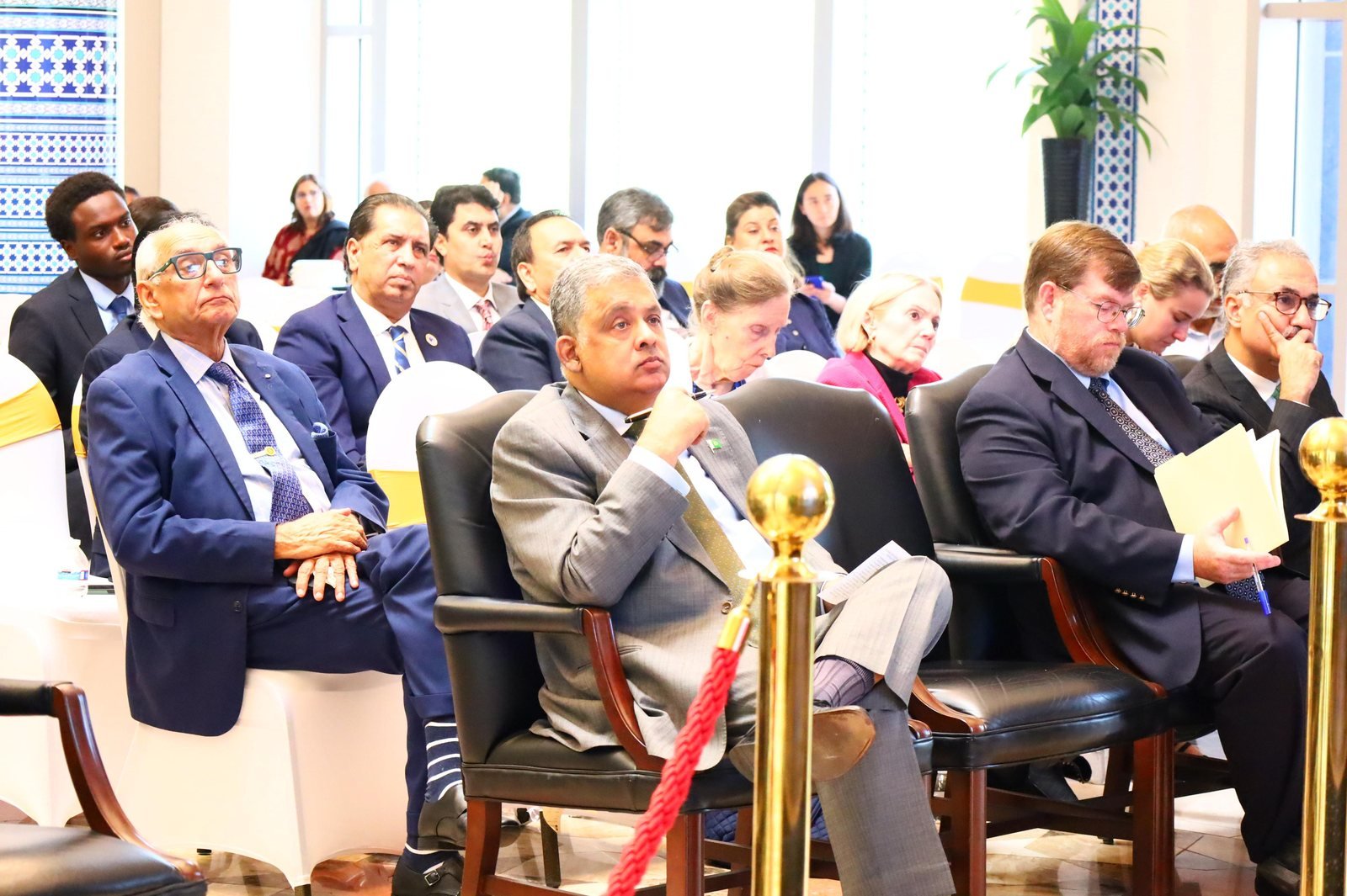 Bilal Anwar seated among the audience at the Indus Waters Treaty seminar, listening to the panel