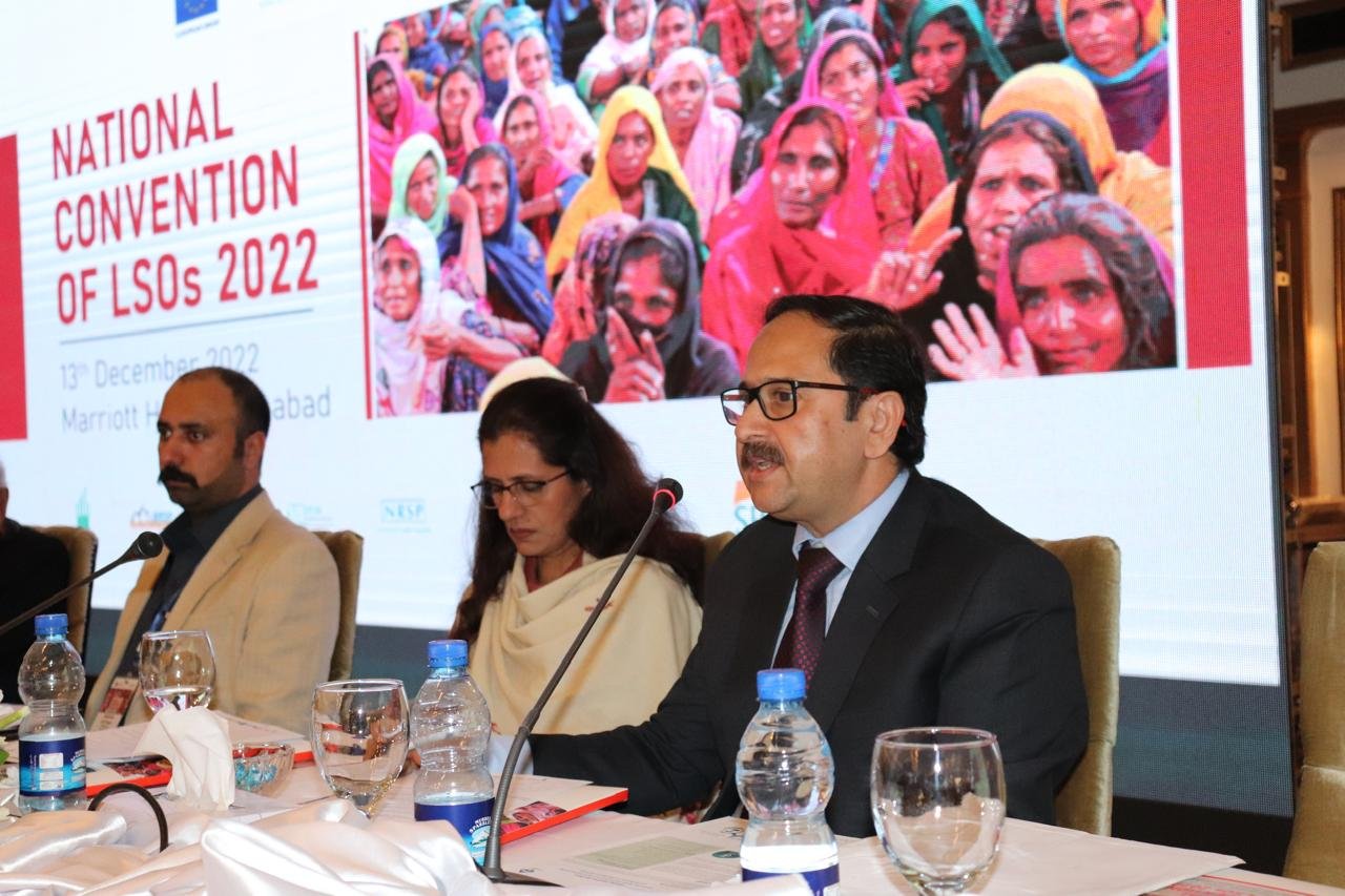 Bilal Anwar speaking from the panel table at the National Convention of Local Support Organisations