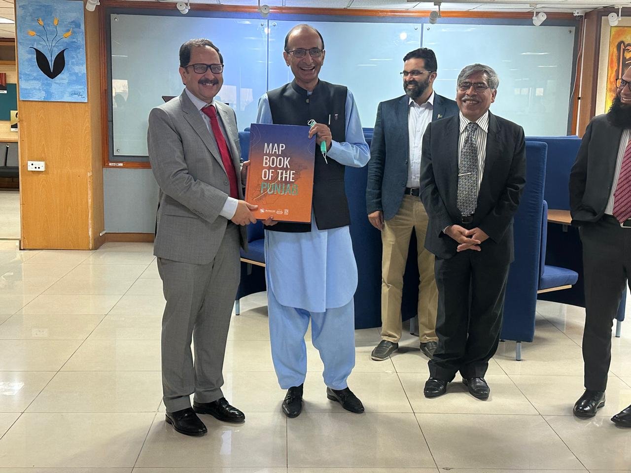 Bilal Anwar presenting a copy of the Map Book of the Punjab