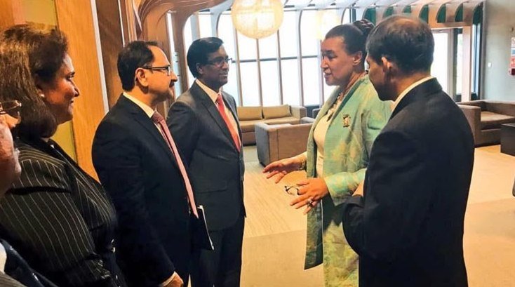 Bilal Anwar and a delegation talking with officials in an airport lounge in Mauritius