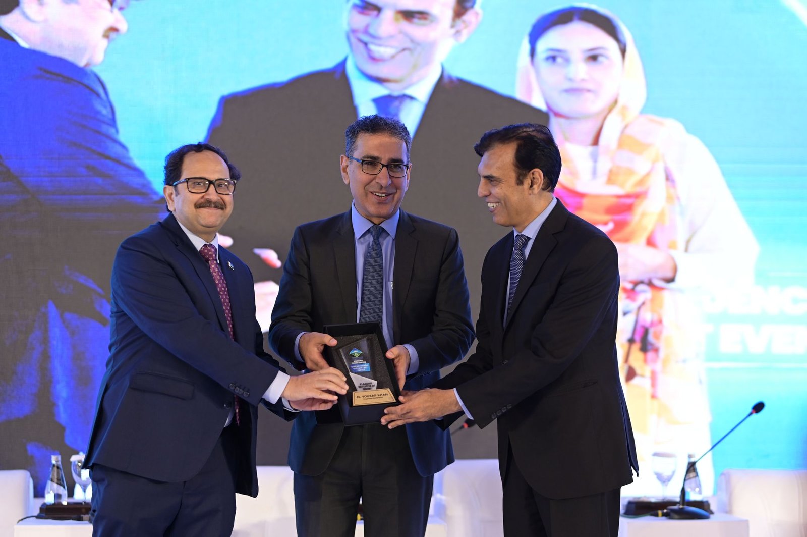 A shield presented on stage for an NDRMF flagship initiative on sustainable finance