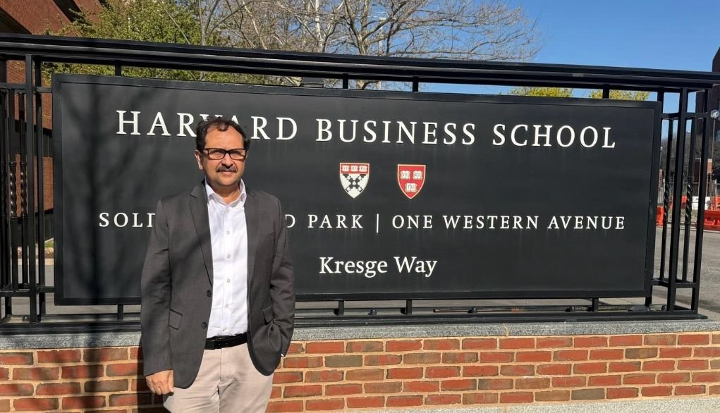 Bilal Anwar beside the Harvard Business School sign at Soldiers Field